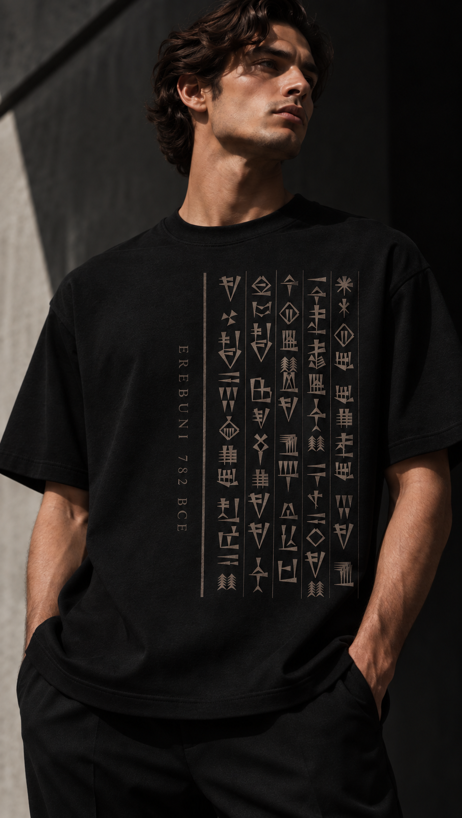 Model wearing a black PeopleOfAr cuneiform T-shirt